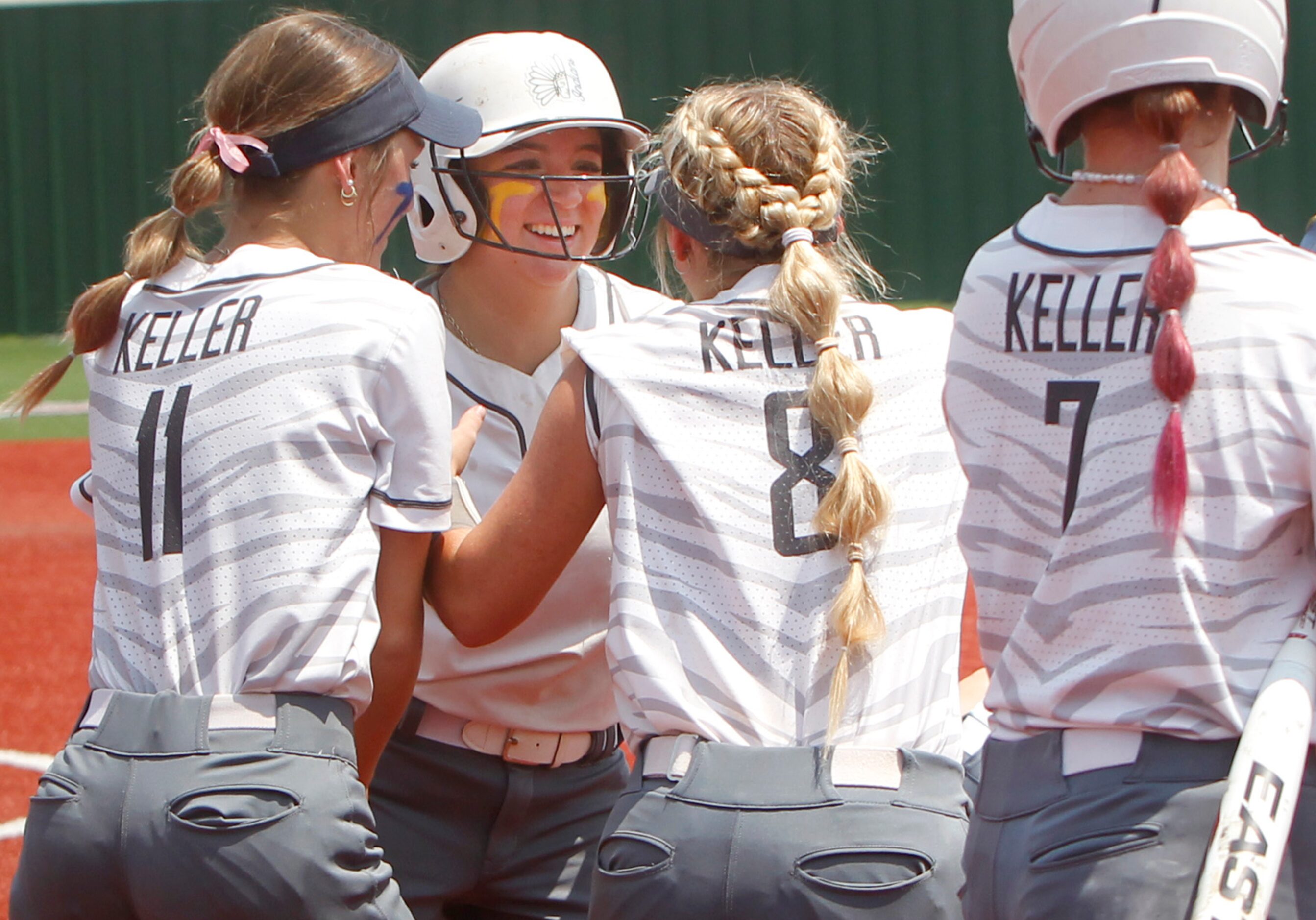 Keller's Marissa Espinoza (10), facing, was all smiles as she celebrated her solo home run...