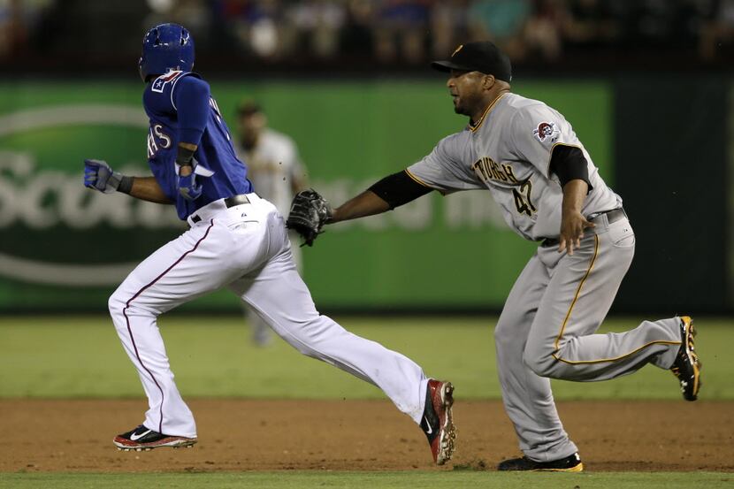 Texas Rangers' Elvis Andrus, left, is picked off stealing second as Pittsburgh Pirates...