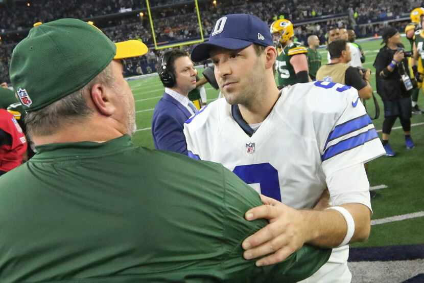 Dallas Cowboys quarterback Tony Romo (9) shakes hands with Green Bay head coach Mike...