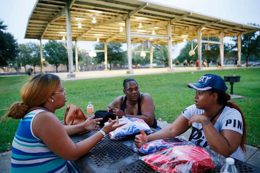 Nyoka Cornelius (right) of Houston talks with her friends 
Octavia LaFayette (left) and...