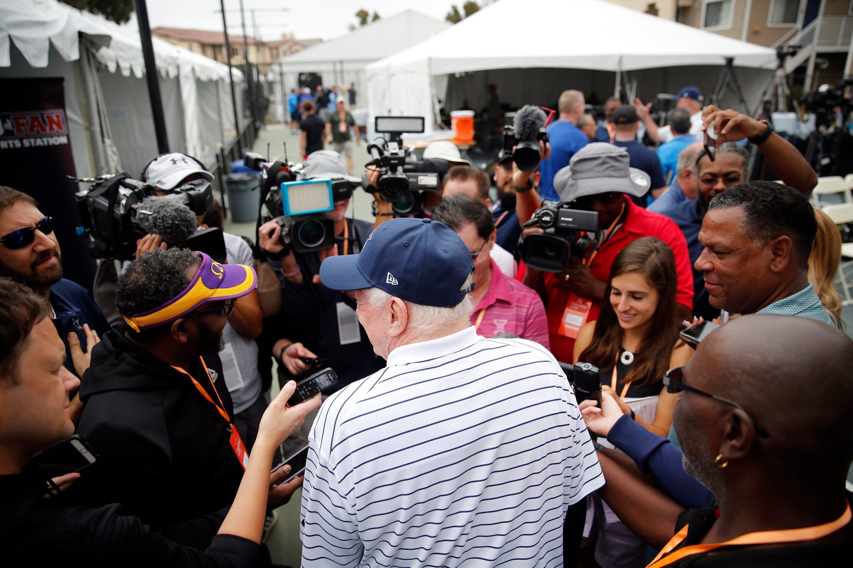 Dallas Cowboys owner Jerry Jones visits with reporters on the side following his kickoff...