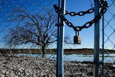 A locked fence surrounds the Bayside development under construction on the Lake Ray Hubbard...