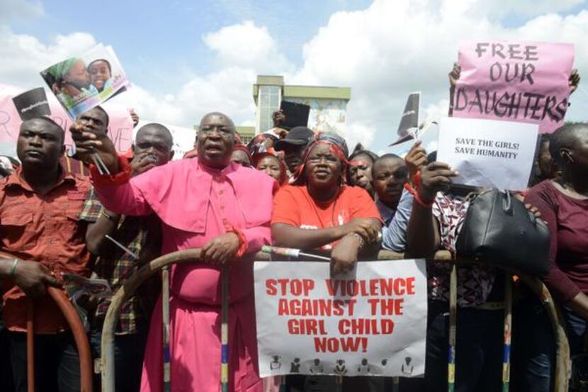 
Members of civil society groups chant outside the Lagos statehouse for the release of...