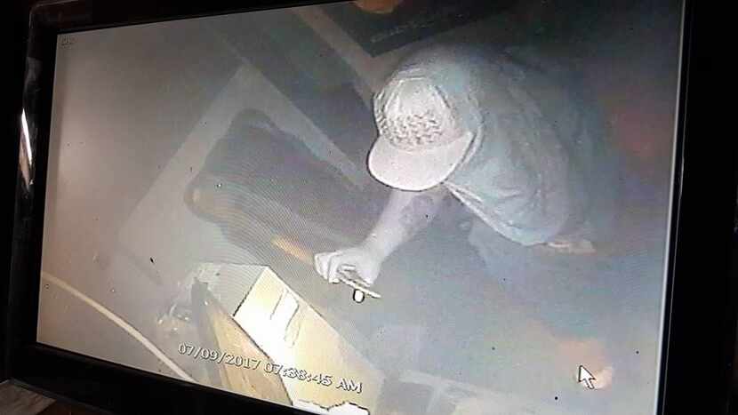 Photo from video surveillance footage of culprit with notable forearm tattoo.