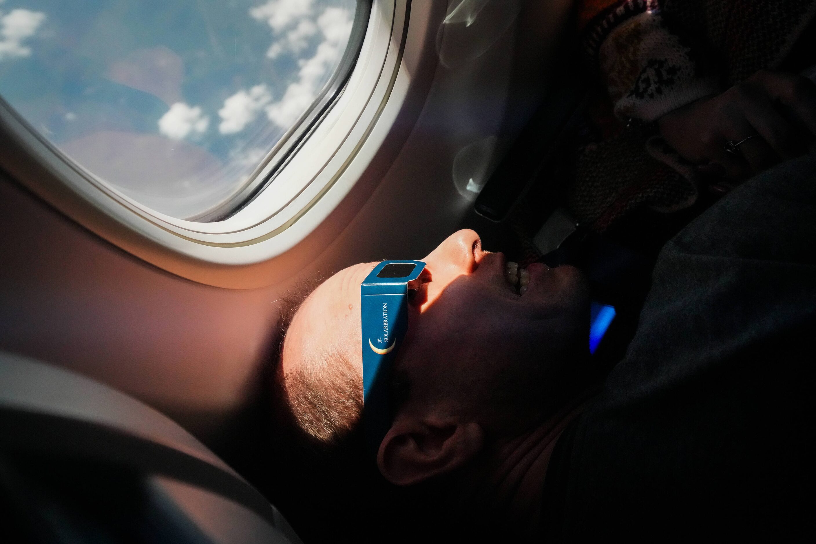 Kevin Hock, from Columbus, Ohio, views the early stages of a total solar eclipse i a...