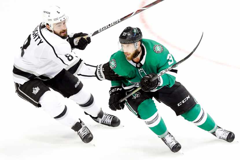 Los Angeles Kings defenseman Drew Doughty (8) reaches out to slow Dallas Stars center Justin...