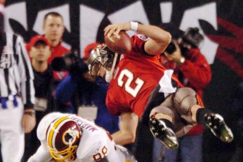 FILE - Tampa Bay Buccaneers quarterback Chris Simms (2) dives over Washington Redskins...