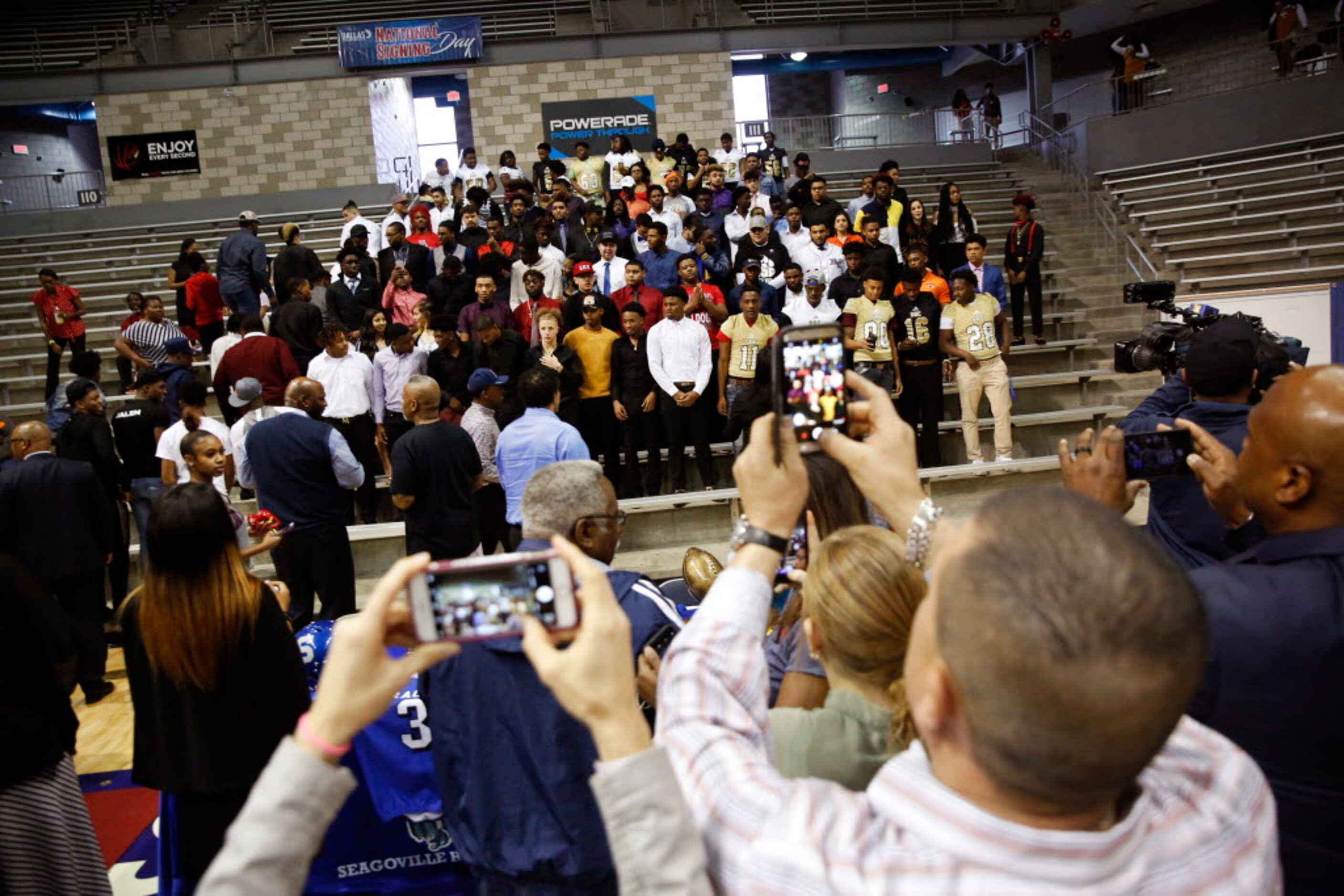 Dallas ISD signees pose for photographs during a  ceremony on National Signing Day at Ellis...