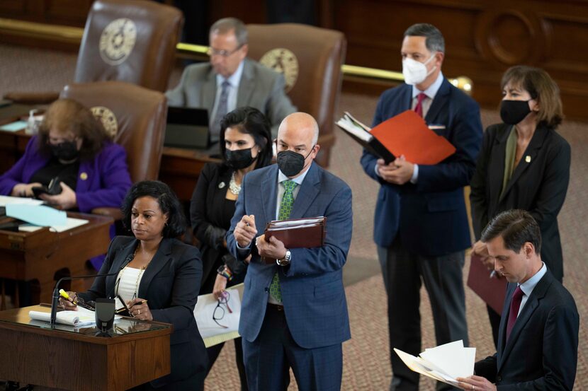 State Rep. NICOLE COLLIER, D-Fort Worth, speaks at the back mic while other representatives...