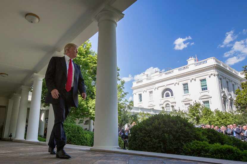 President Donald Trump walks to the Oval Office of the White House in Washington, Thursday,...