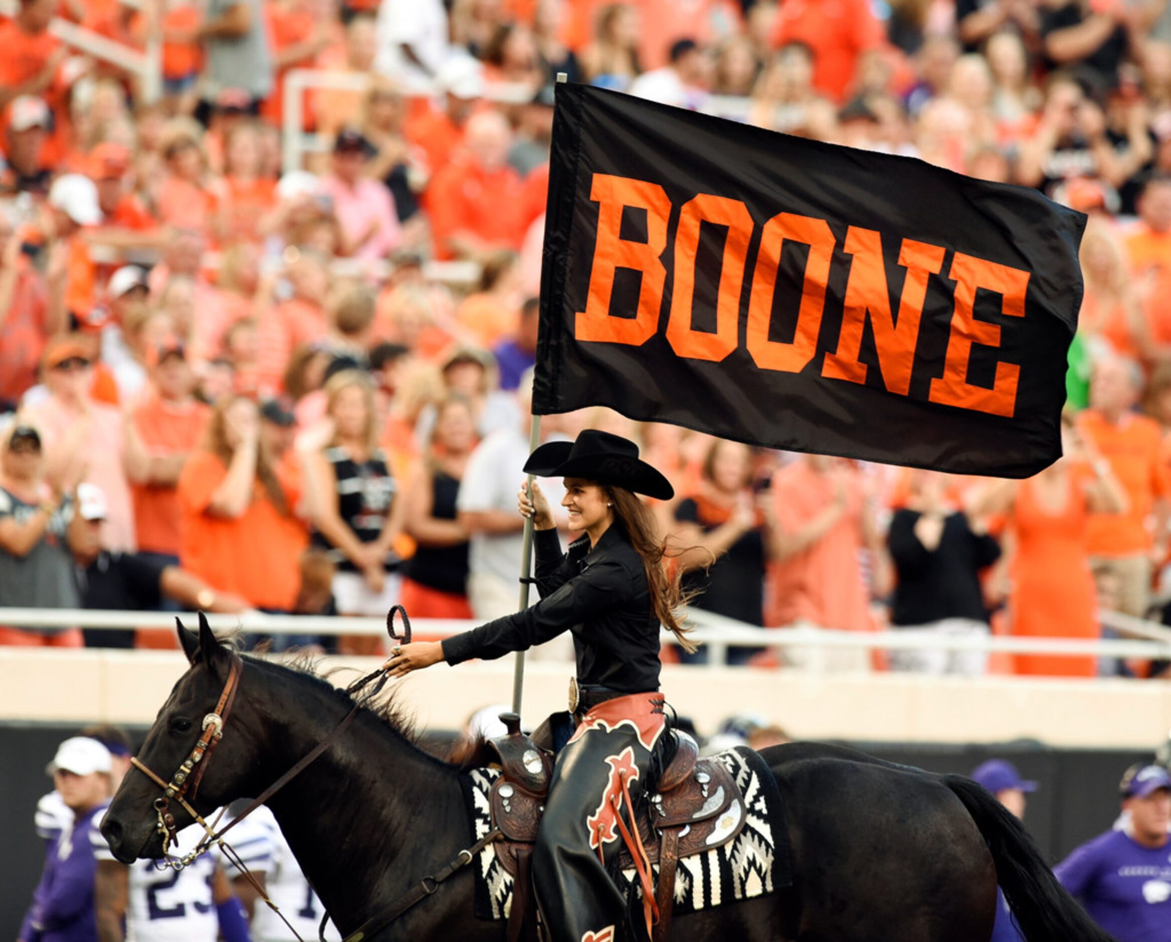 Oklahoma State quarterback Spencer Sanders (3) looks back at Kansas State defensive back...