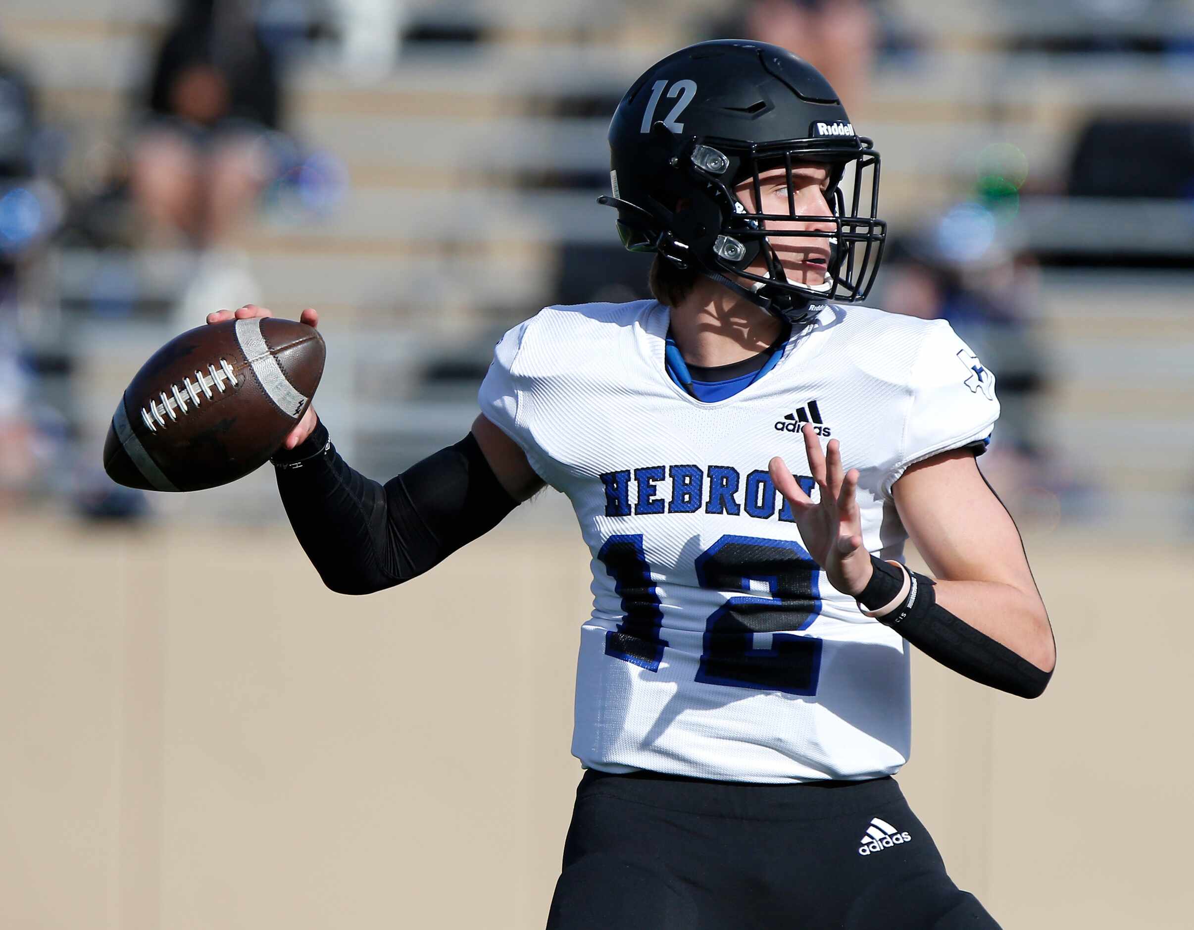 Hebron High School quarterback Weston Conaway (12) throws a pass during the first half as...