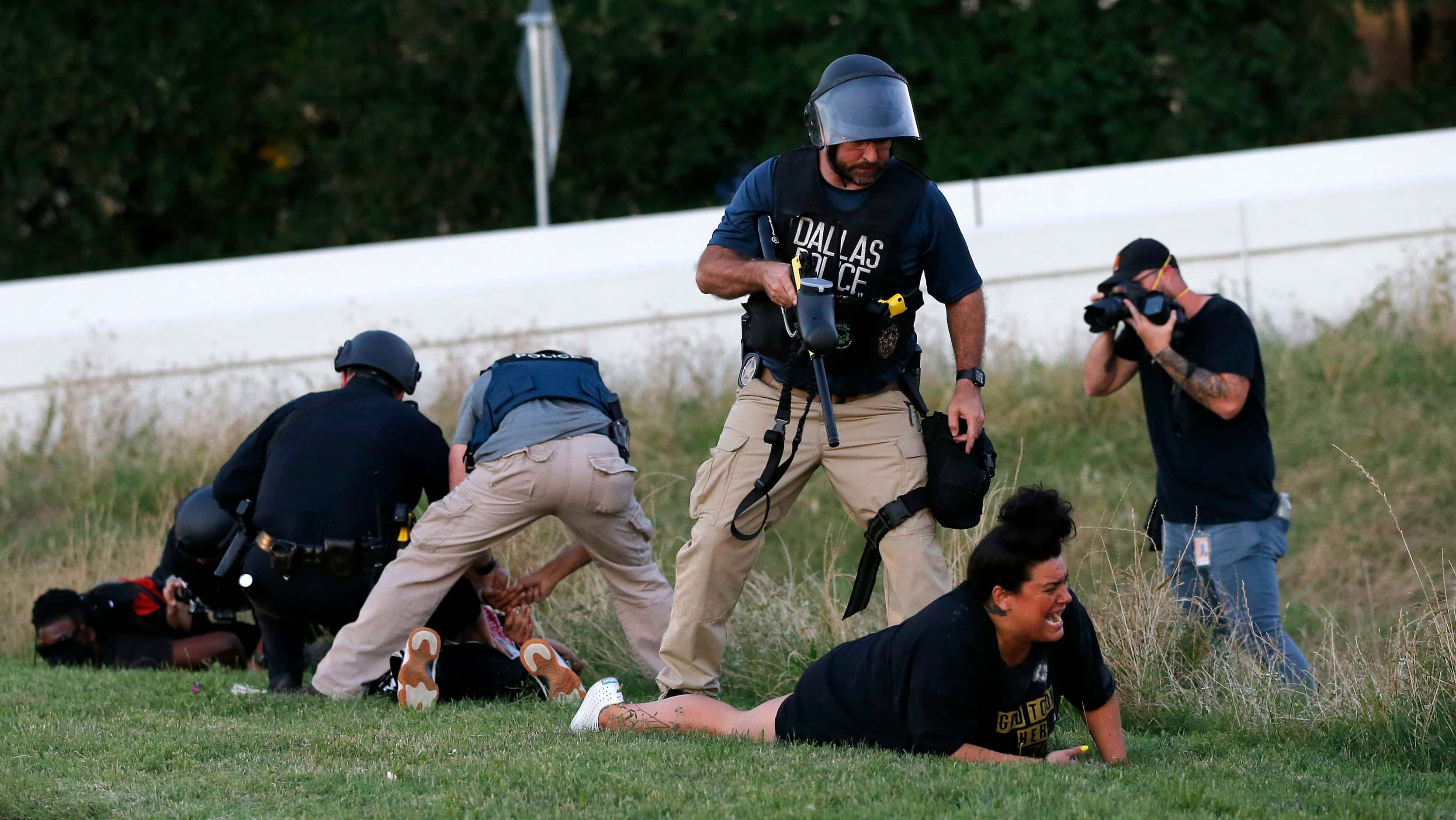 Dallas Police Sgt. Roger Rudloff stands over Jantzen Verastique (center), after shooting her...