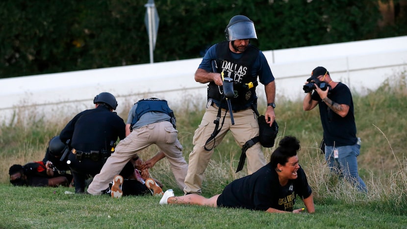 Dallas police Sgt. Roger Rudloff stood over Jantzen Verastique (center) on May 30, 2020,...