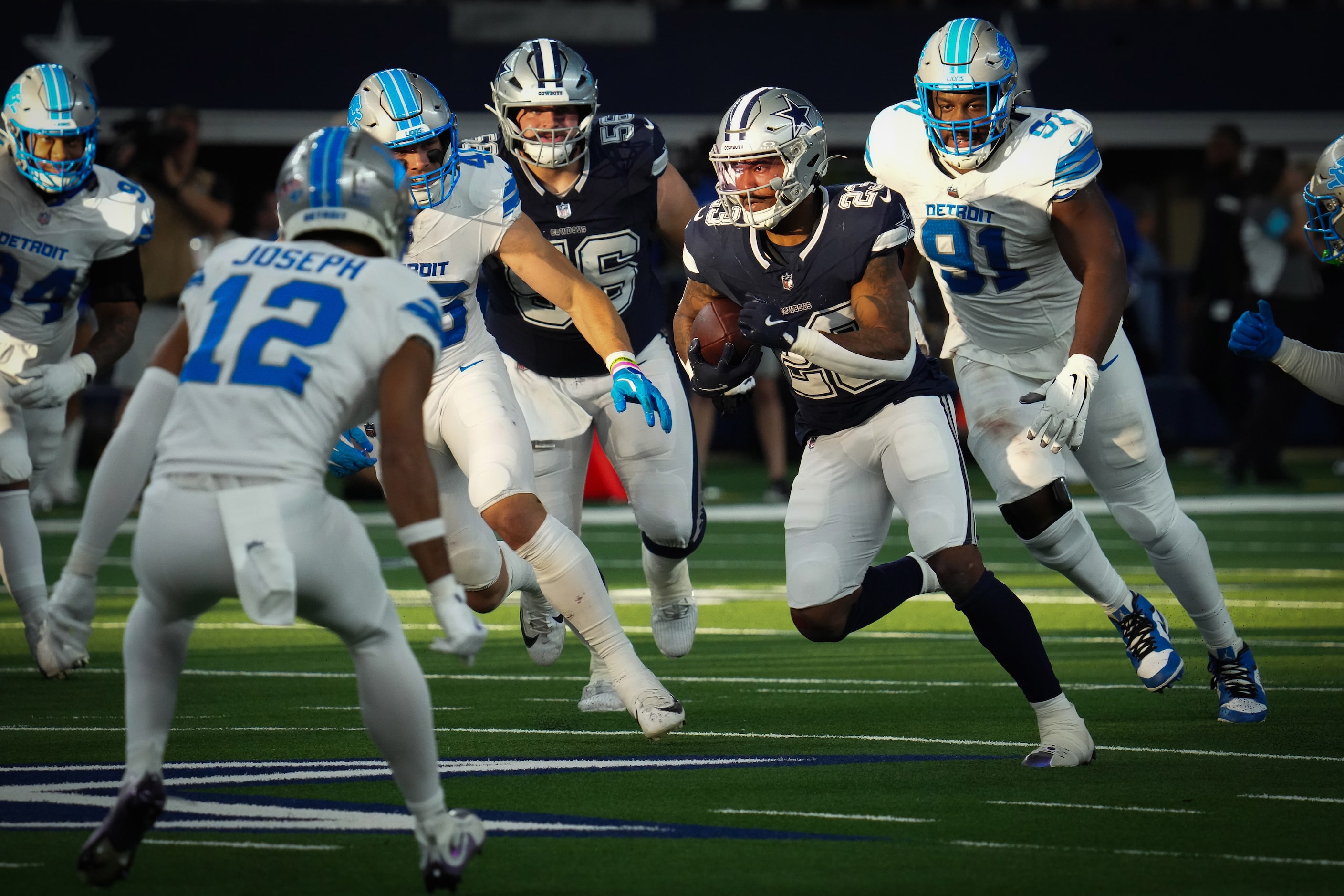 Dallas Cowboys running back Rico Dowdle (23) picks up a first down past Detroit Lions...