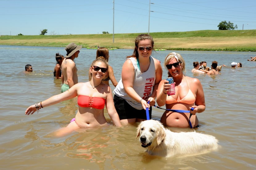 Swimmers bring their dog in the Trinity River for a dip at Sunday Funday at Panther Island...