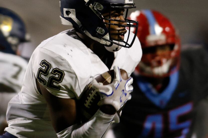 Jesuit running back EJ Smith (22) follows his blocks as he bolts from the Rangers backfield...