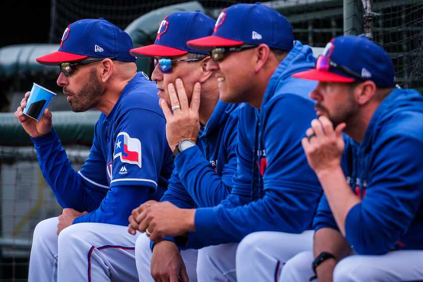 Texas Rangers manager Chris Woodward (from left), bench coach Don Wakamatsu, pitching coach...