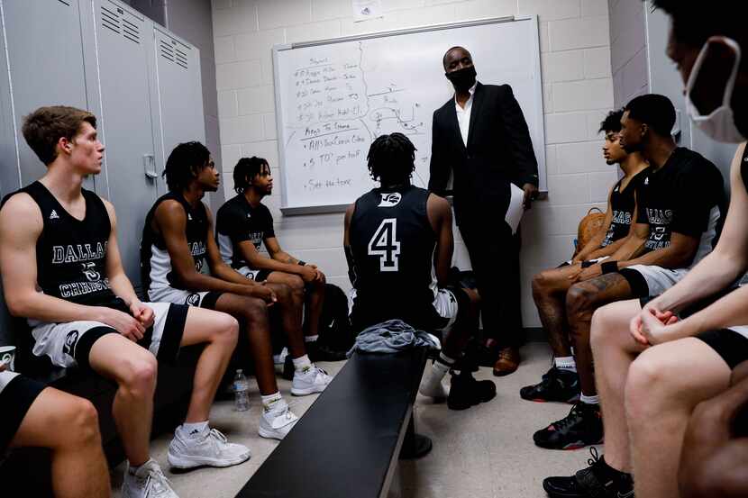 Dallas Christian College basketball players listen to coach Dwight Coleman in the locker...