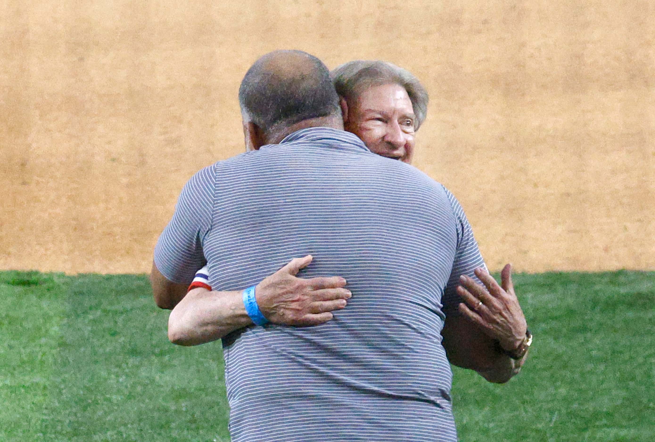Texas Rangers fan Michael Carter of Southlake, Texas receives a hug from National Baseball...