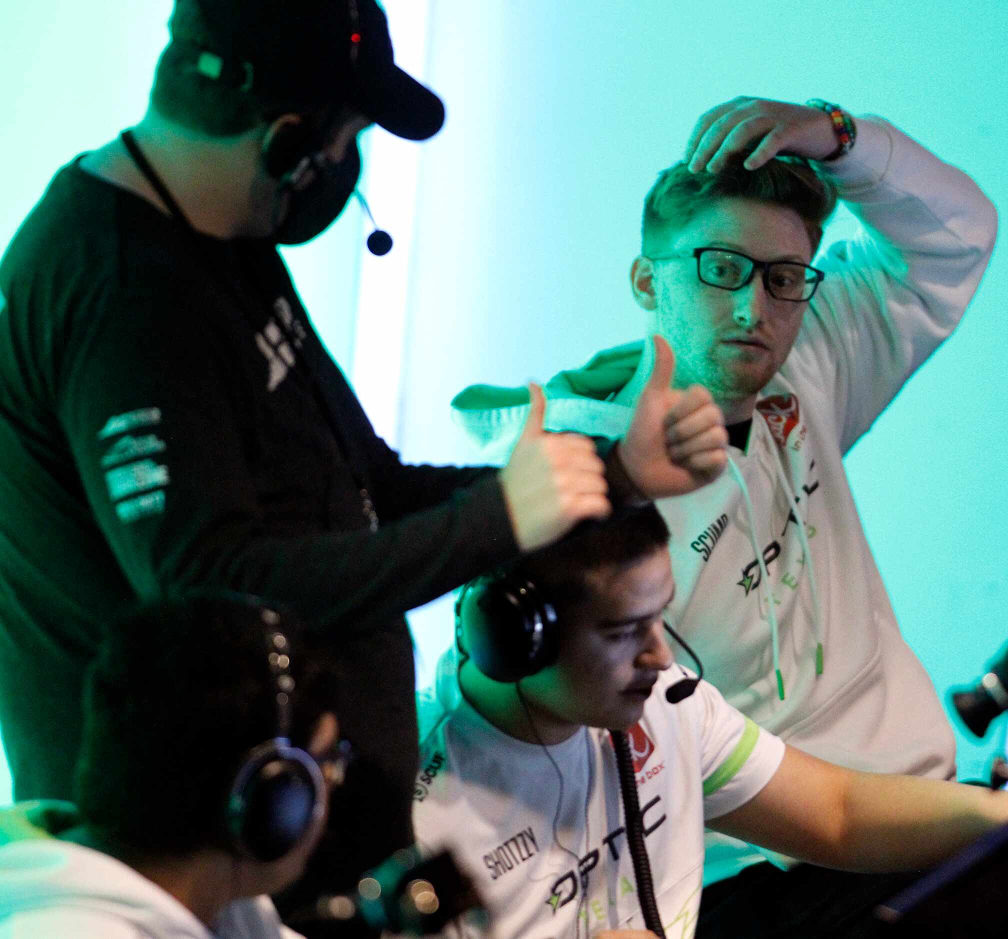 OpTic Texas player Seth "Scump" Abner, top right, listens to the direction of a technical...