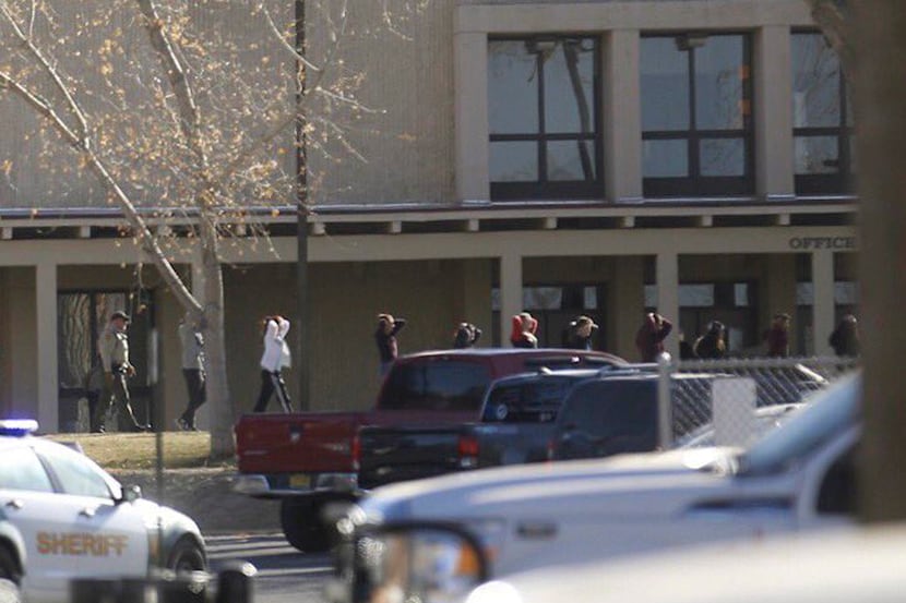 Students were led out of Aztec High School after a shooting Thursday in Aztec, N.M. The...