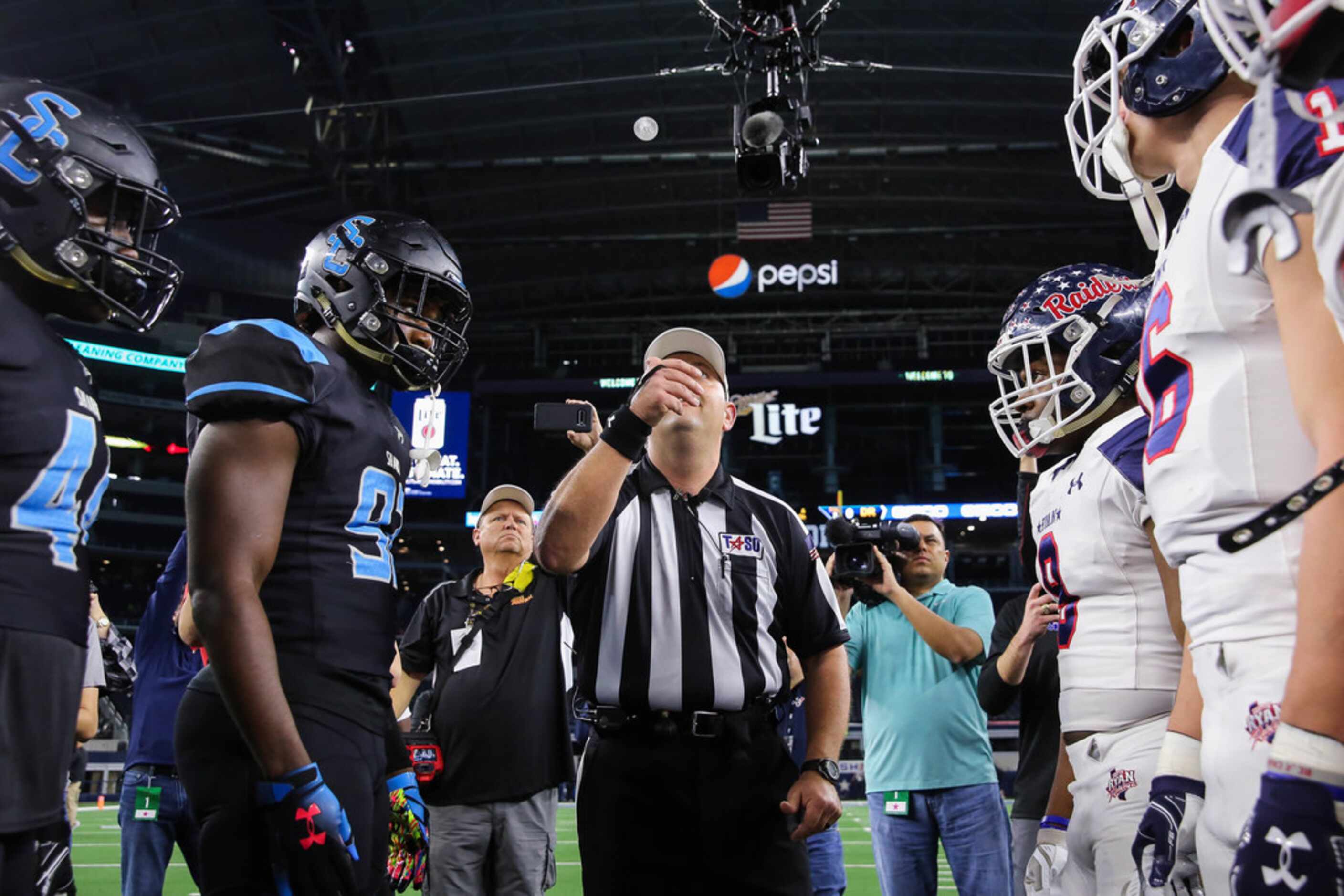 The coin toss before a Class 5A Division I state championship game between Denton Ryan and...