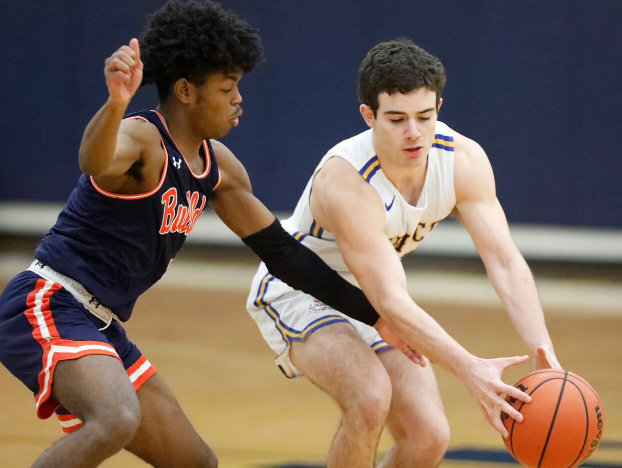 McKinney North High School guard J.J. Henry attempts to steal the ball from Frisco High...