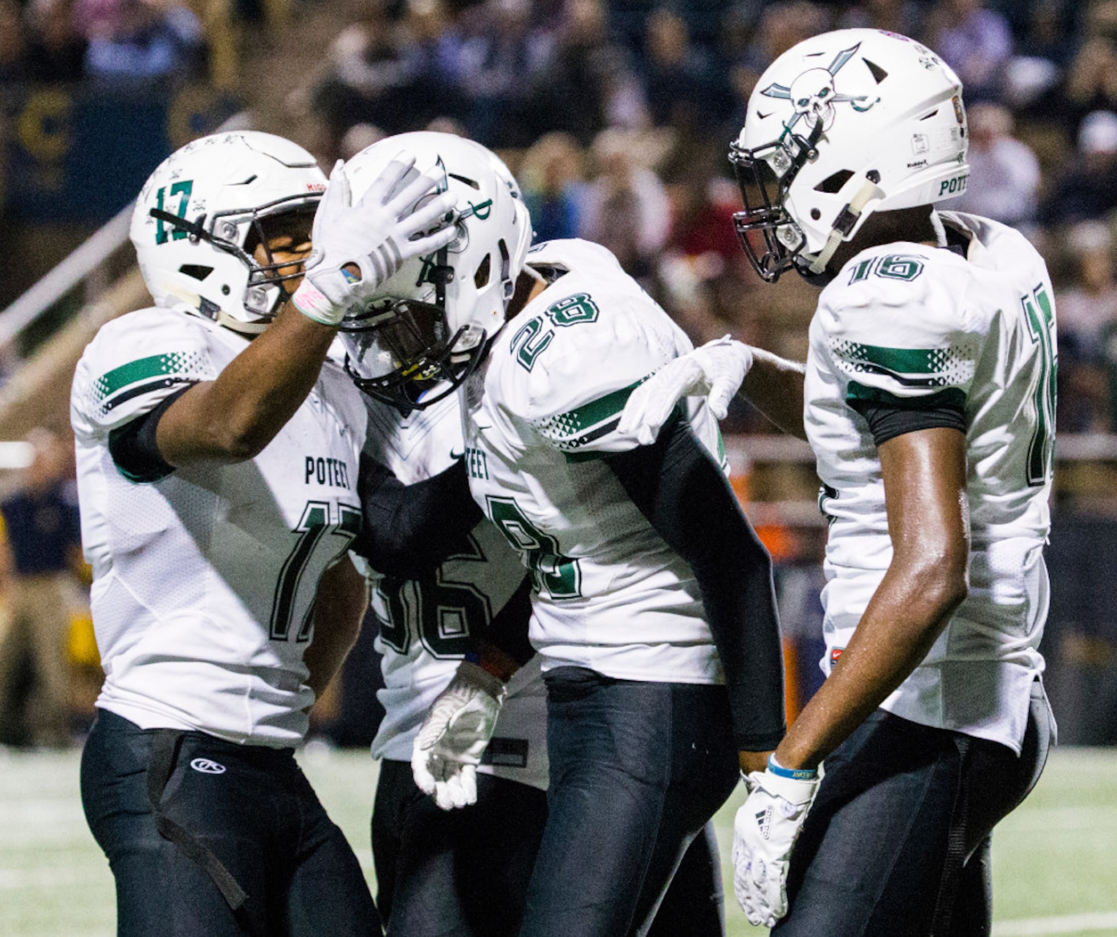 Mesquite Poteet football players celebrate with defensive back Mekhi Garner (28) after he...