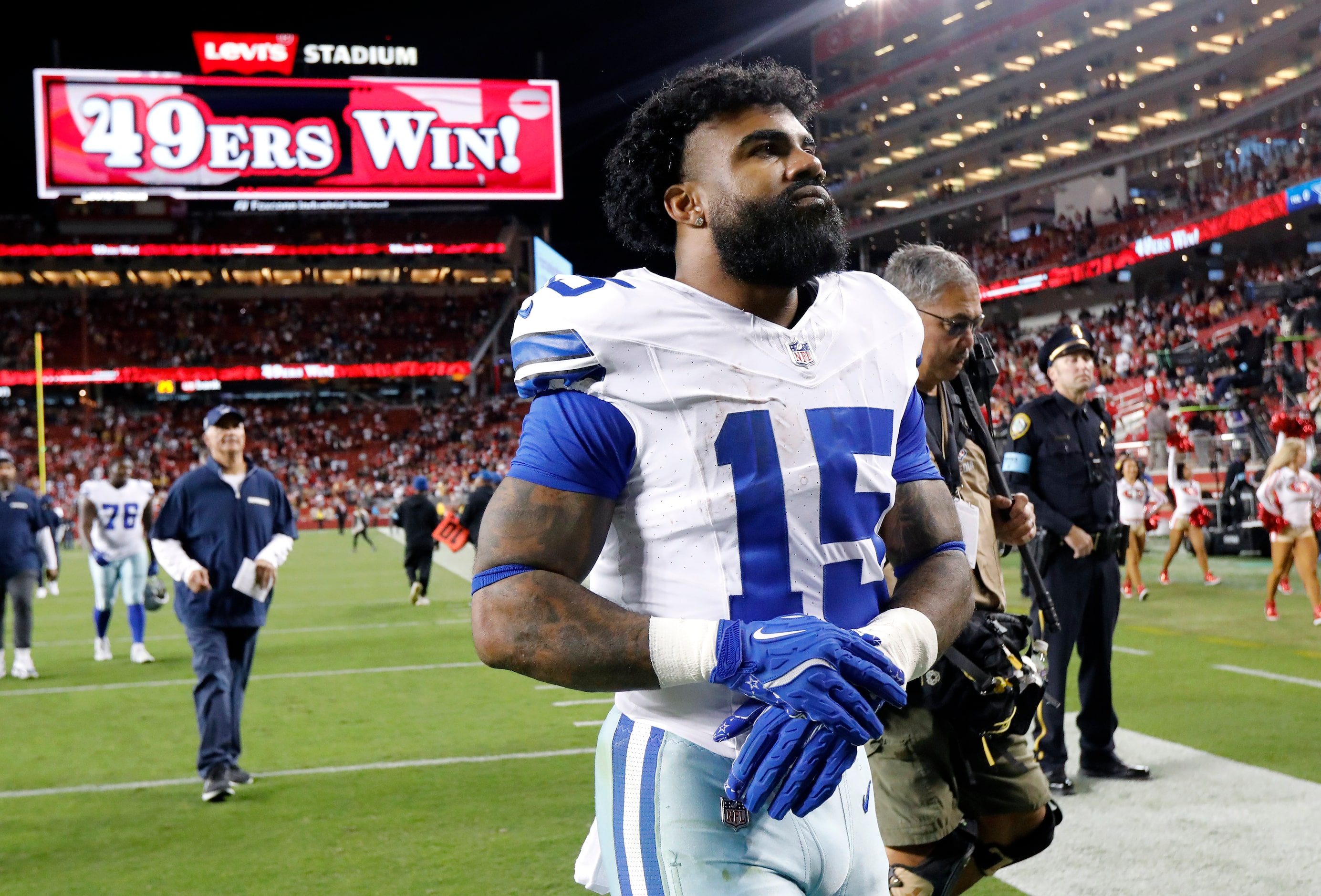 Dallas Cowboys running back Ezekiel Elliott (15) walks of the field following their loss to...