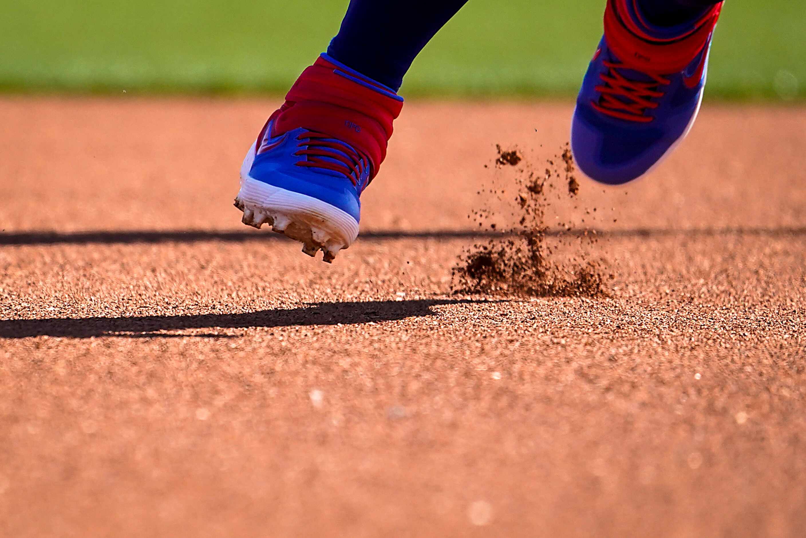 Dirt flies from his cleats as Texas Rangers second baseman Rougned Odor participates in a...
