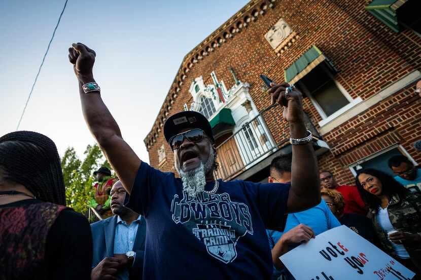 Protestors gather outside the house (not pictured) where Atatiana Jefferson was shot and...