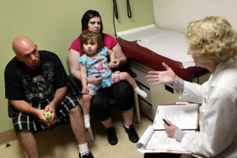 Genetic counselor Michelle Fox, right, talks with William Hanberg and Heather Spear with...
