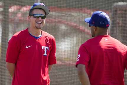 Texas Rangers infielder Corey Seager (facing) laughs with teammate Marcus Semien during a...
