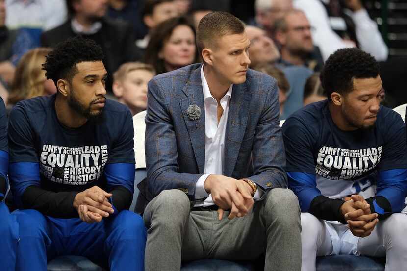Dallas Mavericks forward Kristaps Porzingis watches from the bench during the first half of...