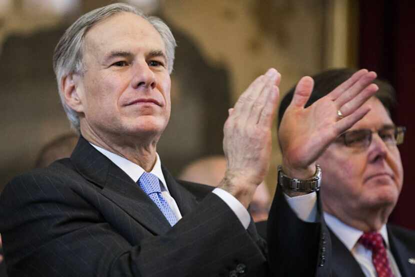  Governor-elect Greg Abbott applauds while listening to Representative Joe Straus, who was...