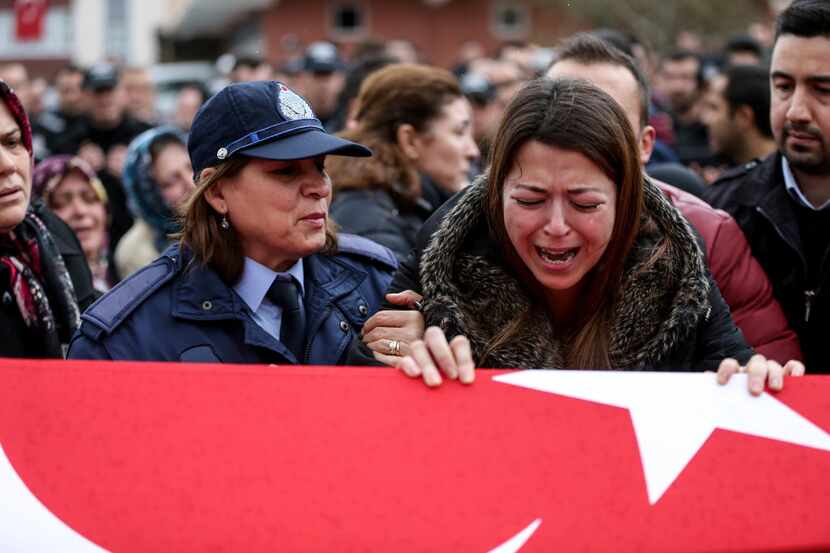 Relatives of police officer Erdem Ozcelik who was killed in bomb attacks outside the...