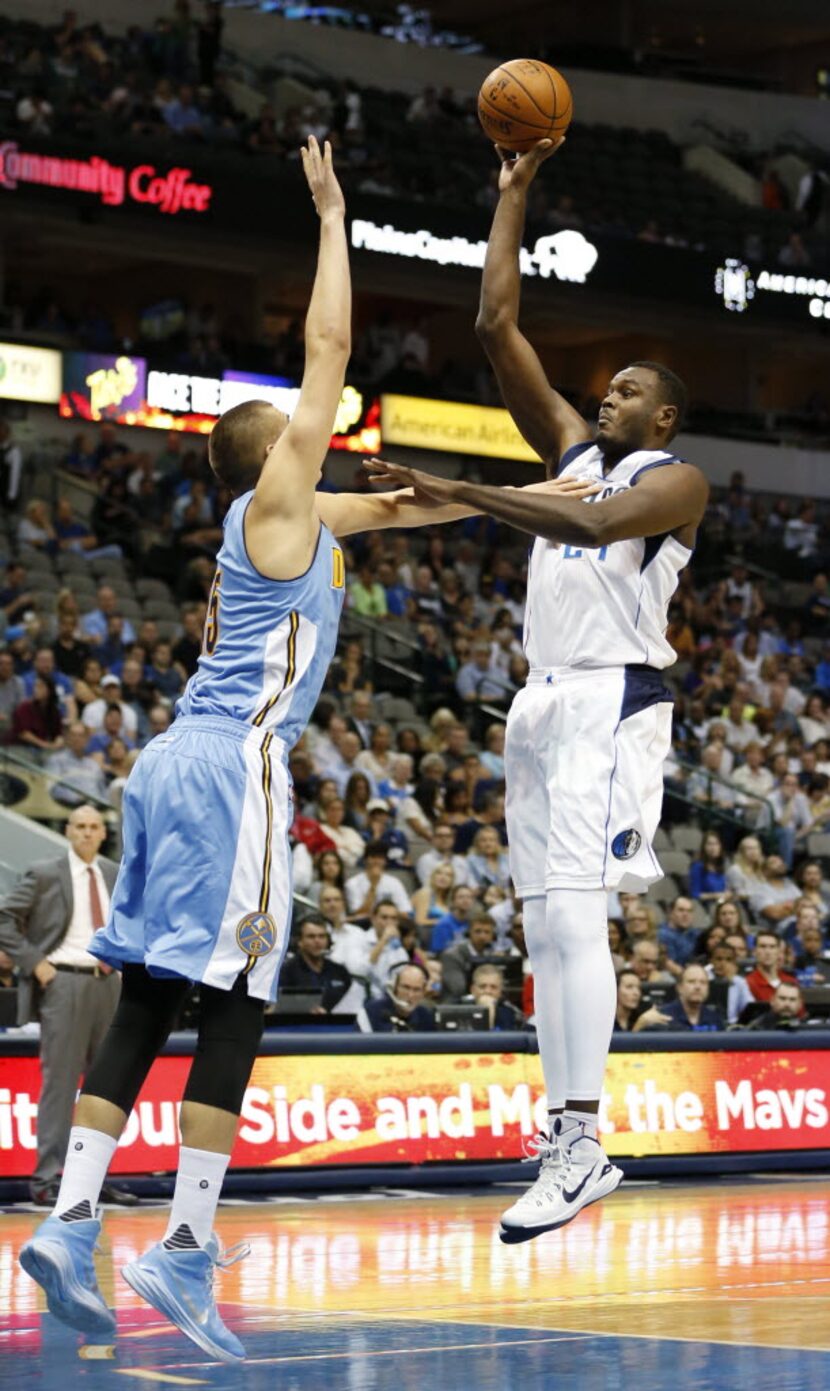 Dallas Mavericks center Samuel Dalembert (24) attempts a shot in front of Denver Nuggets...