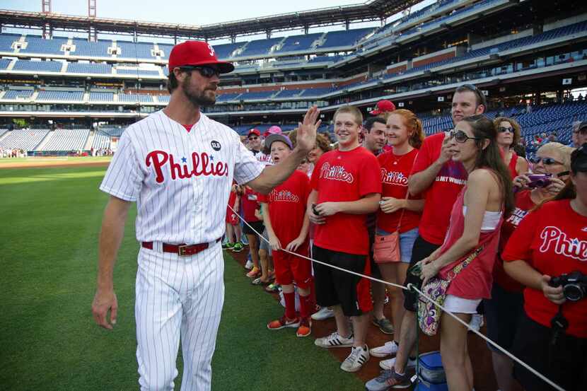 Cole Hamels #35 of the Philadelphia Phillies poses for photos with fans before a game...