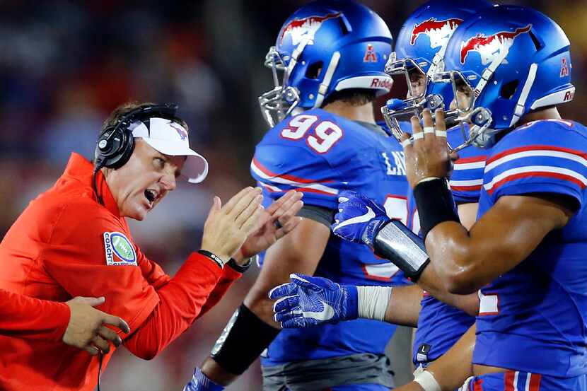 Southern Methodist Mustangs head coach Chad Morris encourages his players to keep fighting...