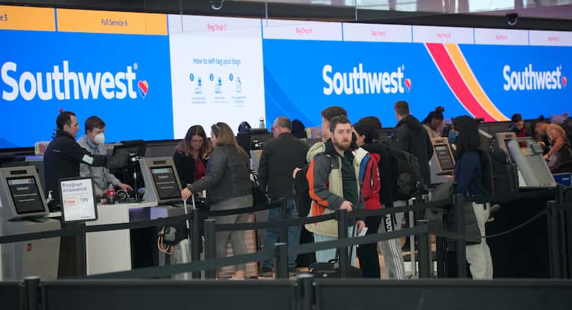 Travelers queued up at check-in counters at Denver International Airport on Dec. 30 to make...