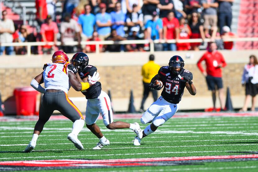 LUBBOCK, TX - OCTOBER 21: Tre King  #24 of the Texas Tech Red Raiders gets some running room...