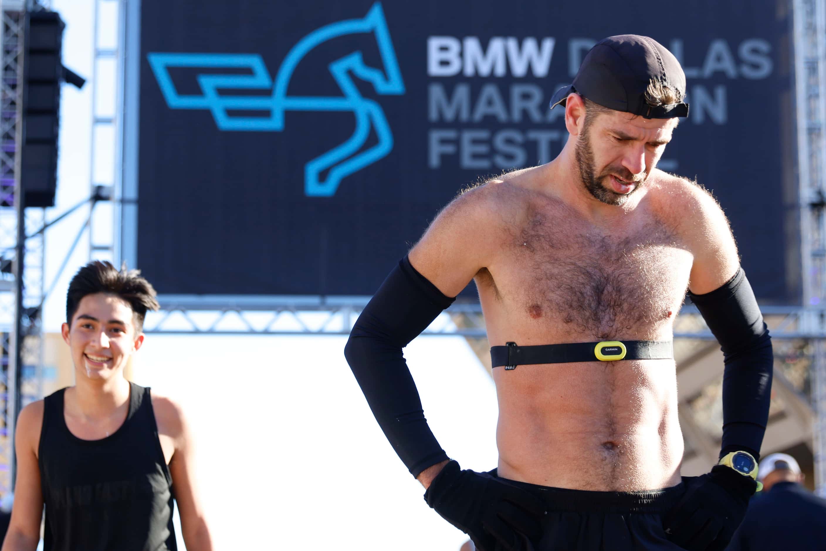 Half marathon runners catch their breath as they reach the finish line during 2023 BMW...