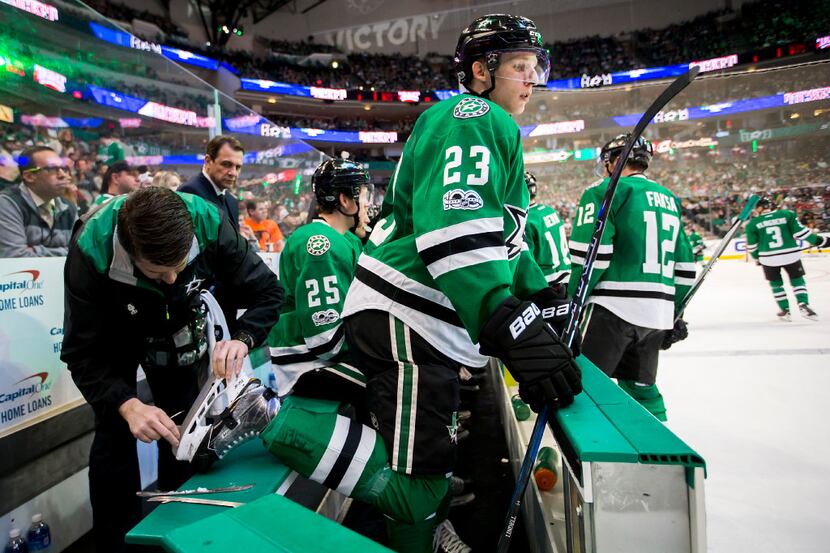 Dallas Stars defenseman Esa Lindell gets a new blade on his right skate during a timeout in...