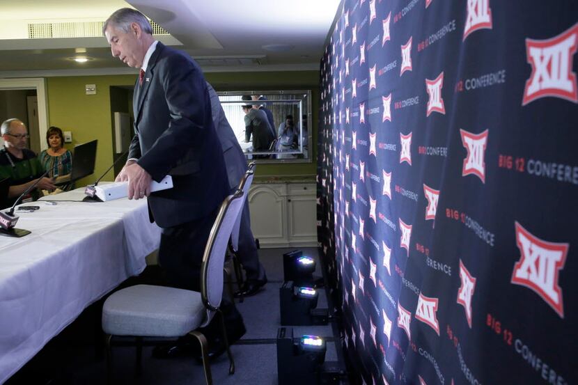 Commissioner of the Big 12 Bob Bowlsby takes a seat before speaking to reporters after the...