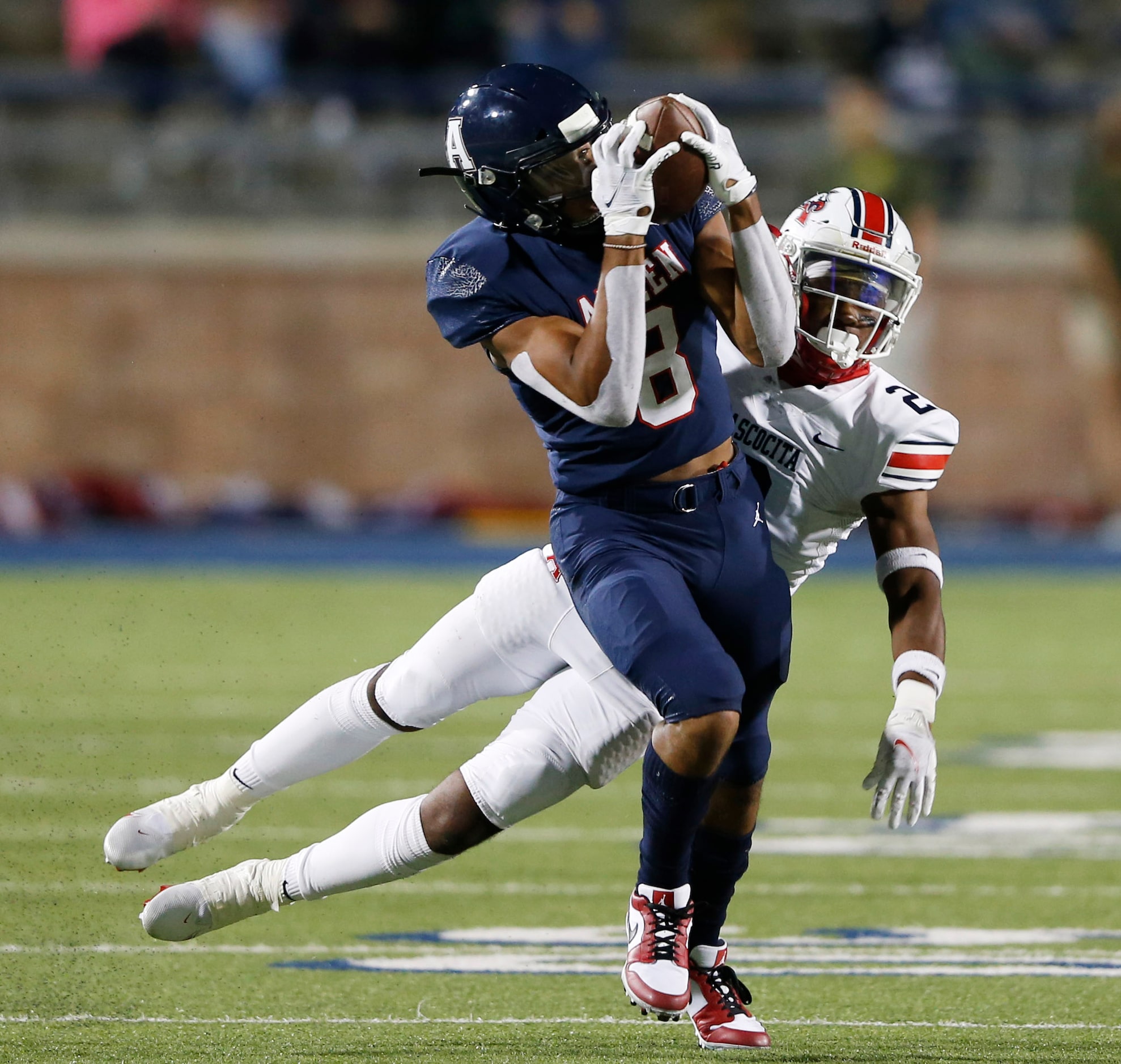 Allen's Blaine Green (8) catches a pass in front of Humble Atascocita's Caleb Burton (2)...