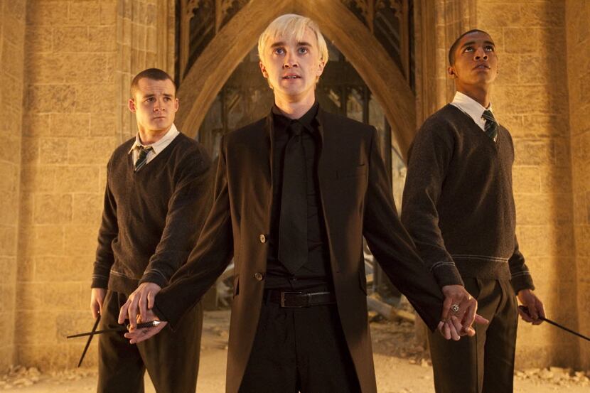 From left, Josh Herdman portrays Gregory Goyle, Tom Felton portrays Draco Malfoy and Louis...