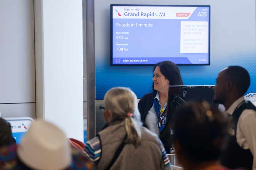 Stacy Edwards, American Airlines customer service agent waits to board passengers on a...