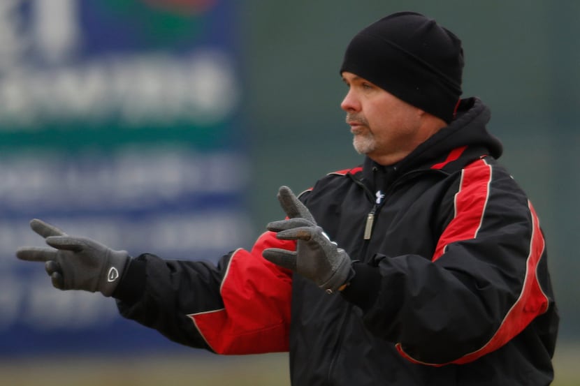 Alan McDougal, head varsity baseball coach at Colleyville Heritage High School, directs his...