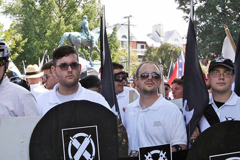  James Alex Fields Jr. (second from left) holds a black shield on Aug. 12 in...